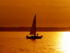 man on sailboat at sunset
